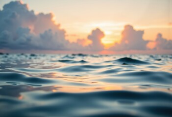 Obraz premium Serene ocean waves reflecting the warm glow of a sunset on the horizon