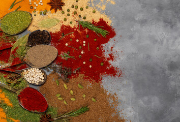 Spices turmeric and paprika in spoons and scattered. Top view.