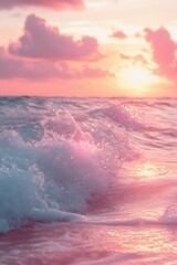 Vibrant sunset over the ocean with gentle waves reflecting soft pink and orange hues