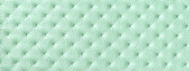 Texture light green and mint leather background with capitone pattern, macro. Pastel cyan textile, Chesterfield style.