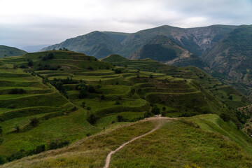 Chokhsky terraces Dagestan. Landscape of mountainous Dagestan with terraced fields and peaks mountains in the distance.