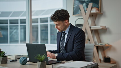 Frowned entrepreneur checking papers sitting desk closeup. Tensed businessman