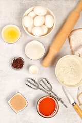 Cooking ingredients for making pie and bread, recipe with eggs, flour, sugar, honey, cinnamon, yeast and butter. Kitchen background of food preparation with space for text. Concept of modern bakery,