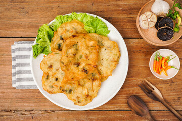 Bakwan sayur is a typical Indonesian vegetable fritter. The ingredients are made from wheat flour mixed with cabbage, carrots, and bean sprouts. Indonesian street food.