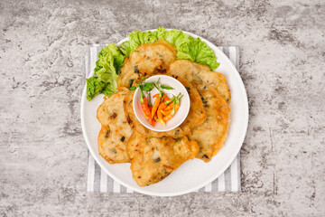 Bakwan sayur is a typical Indonesian vegetable fritter. The ingredients are made from wheat flour mixed with cabbage, carrots, and bean sprouts. Indonesian street food.