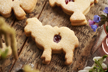 Linzer cookie in the shape of Easter sheep filled with strawberry marmalade and dusted with sugar