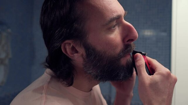 Man Trimming His Beard in the Bathroom During His Morning Routine