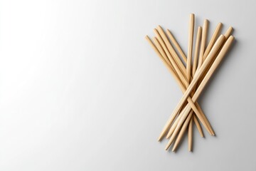 Wooden chopsticks arranged on a plain background