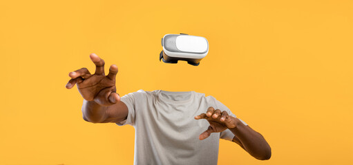 User engages with virtual reality technology, wearing goggles without a visible face.