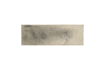 A used sharpening stone with visible wear is isolated.