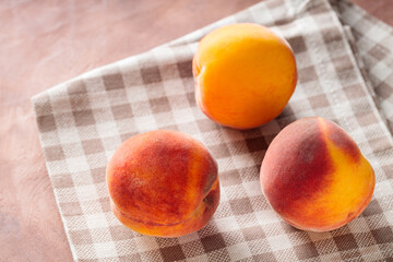 Fresh Peaches on Beige Checkered Napkin, Copy Space