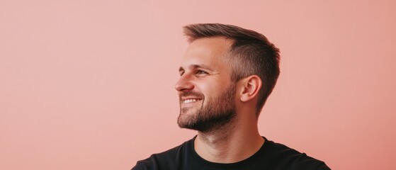 Obraz premium Smiling Caucasian man looking to the side with a positive attitude against a pink background Headshot of a happy adult with a beard in casual clothing