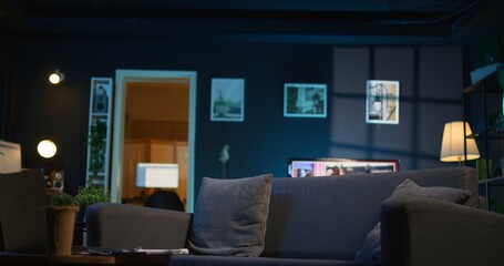 Cozy high end apartment illuminated with neon lights and a big tv, home theatre and setup for a young adult. Empty loft decorated and equipped with electronics, comfortable space.