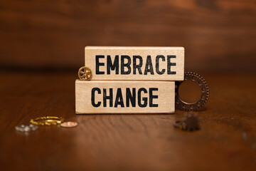 EMBRACE DIGITAL CHANGE inscription on a notebook in the hands of a businessman