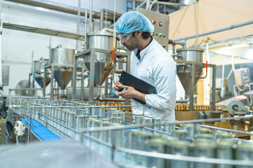 Professional closely examining production materials on a conveyor system, representing dedication...