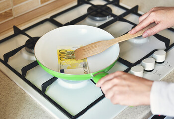 Conceptual Photo of Frying Money in a Pan
