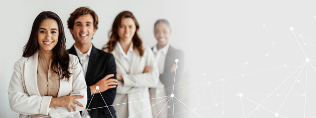 Multiracial business team standing in line with folded arms smiling at camera posing in office interior, selective focus on latin businesswoman. Leadership concept