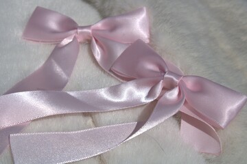 pink hair bows sitting on white fur