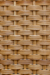 Wooden texture of rattan furniture close-up. Vertical background. Selective focus