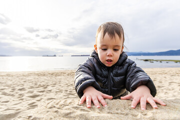 Young Child Playing on a Sandy Beach at Stanley Park in Vancouver