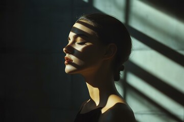 Asian Woman in Contemplation with Dramatic Light and Shadow on Face - Profile