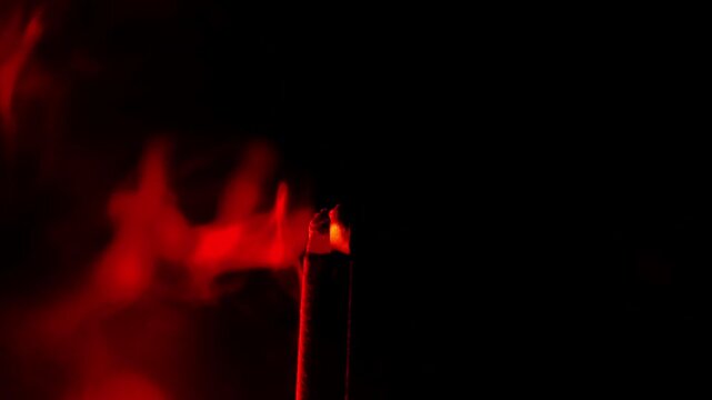 Incense sticks.moky wallpaper in black and red tones.Magic and sorcery atmosphere. 4k footage