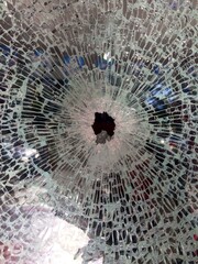 Broken glass with bullet hole