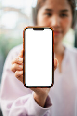 Close-up of a woman holding a smartphone with a blank screen, perfect for app or website mockups.