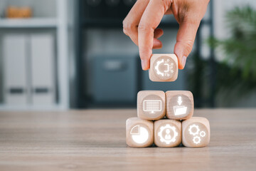 Wooden blocks with digital icons representing asset management, organization, and workflow efficiency.