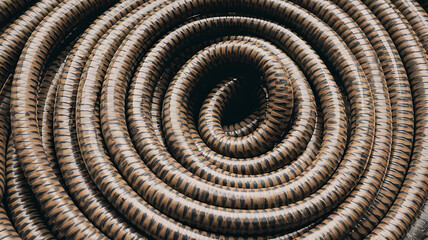 Close-up of coiled patterned PVC pipes