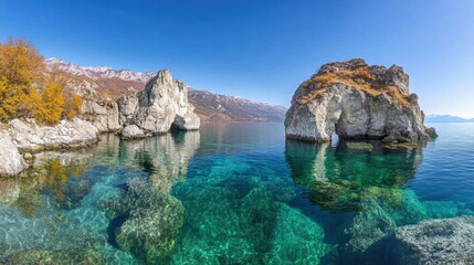 Obraz premium Serene autumn landscape with rocky shores and crystal-clear waters
