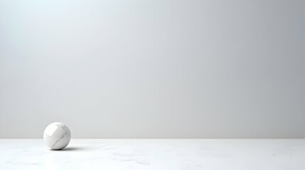 White Geometric Sphere Resting On A White Surface With Gray Background And Soft Lighting