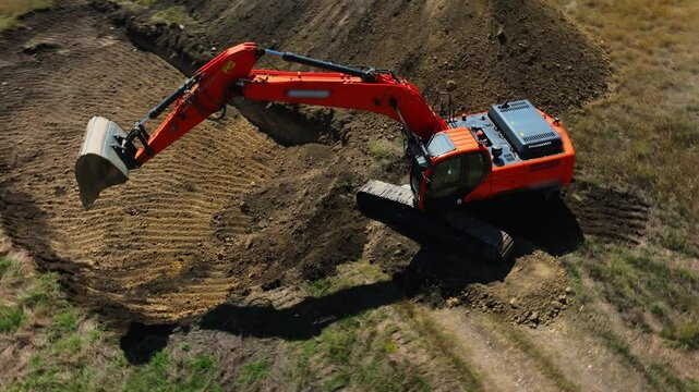  Excavator with big shovel in the excavation of the construction site. One machine works at a quarry, moving dirt. Heavy machinery at industrial construction site. Excavator digging soil pits 