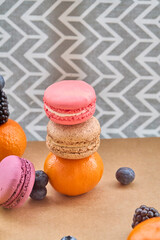 Vibrant Macarons with Fresh Berries and Oranges
