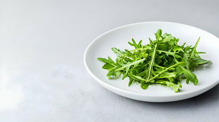 Fresh Green Arugula Leaves Displayed Elegantly On A White Ceramic Plate Against A Soft Gray Background