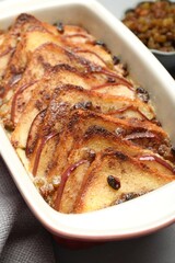 Delicious bread pudding in baking dish on table, closeup