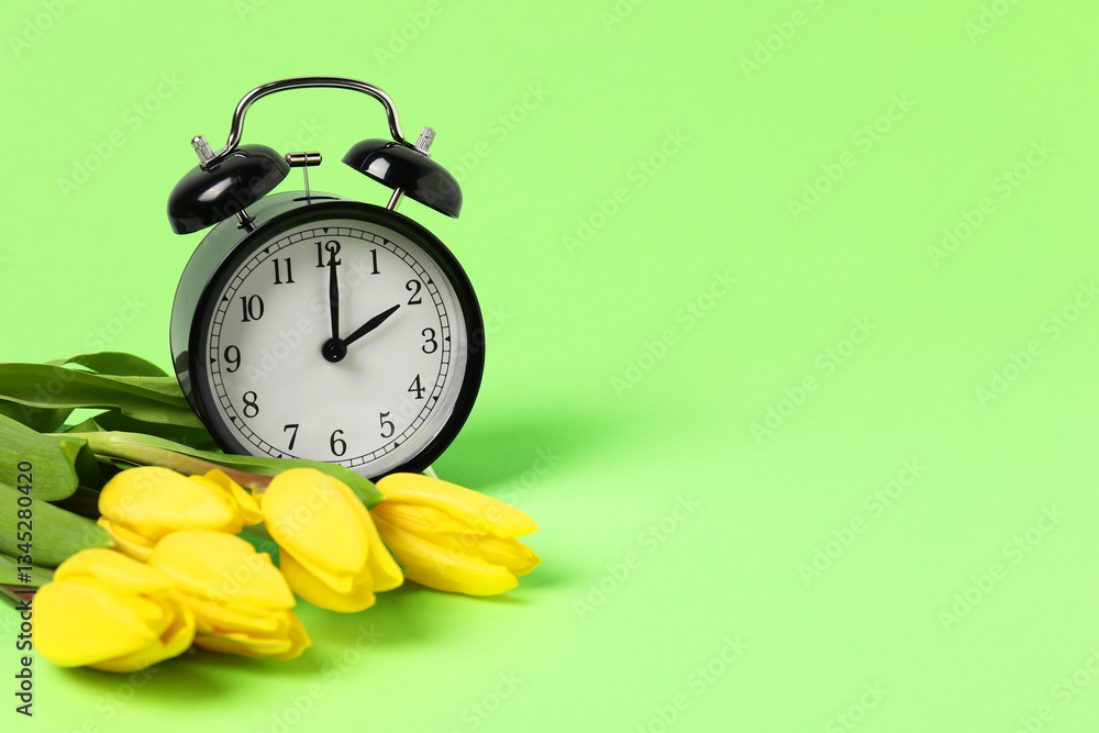Poster spring time. alarm clock and beautiful tulips on green background, space for text