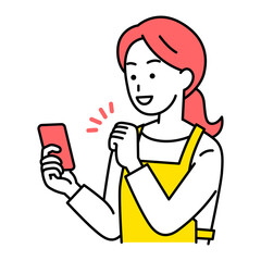 スマートフォンの画面を見てガッツポーズで喜ぶエプロン姿の女性