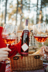 Two young caucasian woman have picnic drink wine in the forest