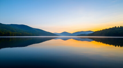 Fototapeta premium Serene Lake Reflecting Sunrise Colors and Hazy Mountain Silhouettes in Nature's Tranquil Landscape
