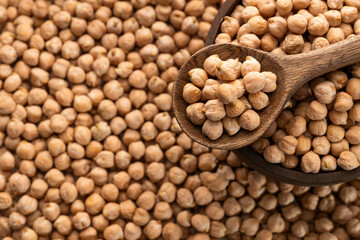Cicer arietinum - Organic dried chickpeas in the bowl and wooden spoon.