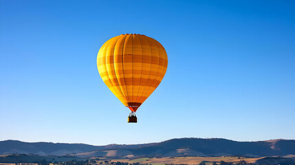 Obraz premium Yellow Hot Air Balloon Floating in Bright Blue Sky During Daytime with Distant Mountain Range