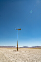 Tall Telephone pole above Desert