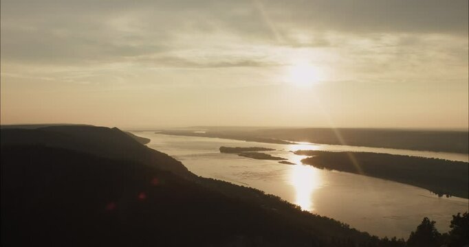 Scenic sunset over river landscape with lens flare