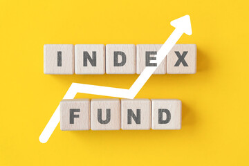 INDEX FUND text on wooden cube blocks with increasing graph on yellow background
