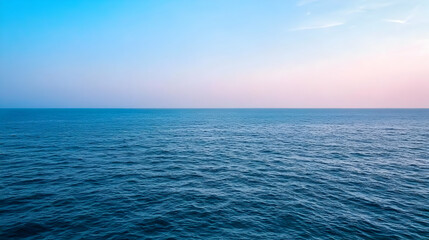 Fototapeta premium Blue Ocean Surface Under A Pastel Sunset Sky Horizon With Light Reflections