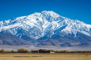 Majestic Snow Capped Mountain Landscape Featuring an Old Abandoned Building