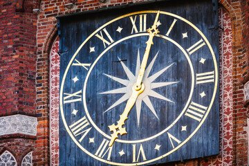 Historic clock tower in Torun's Old Town Market showcases intricate design and timeless charm