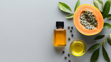 Papaya Oil And Leaves Flat Lay On Gray Background
