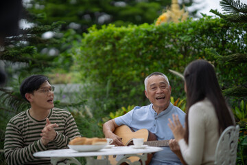 Happy Asian family enjoy spend time together at park with smile and laugh. Elderly senior man plays...